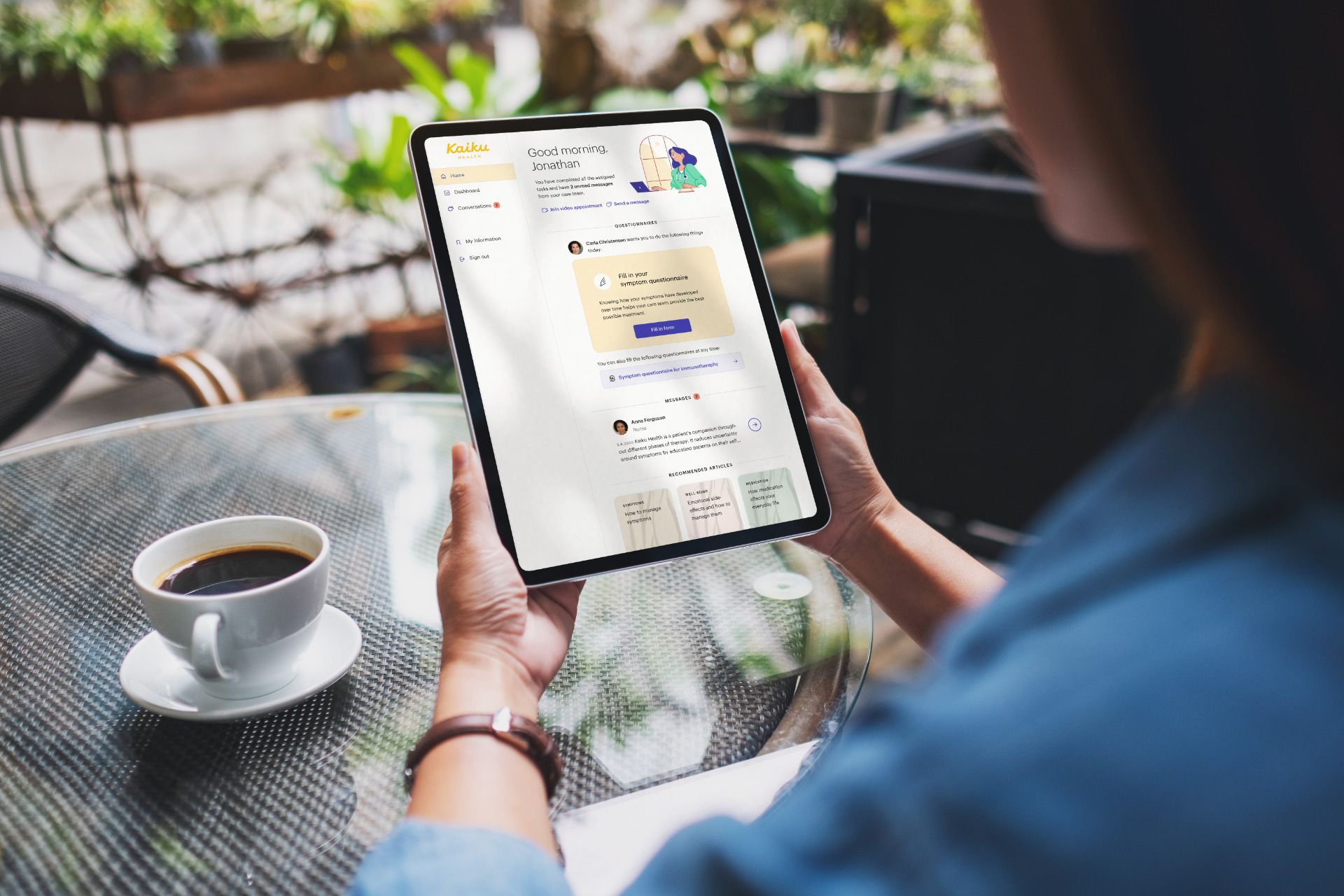 Woman sat at a coffee table with Kaiku open on a tablet